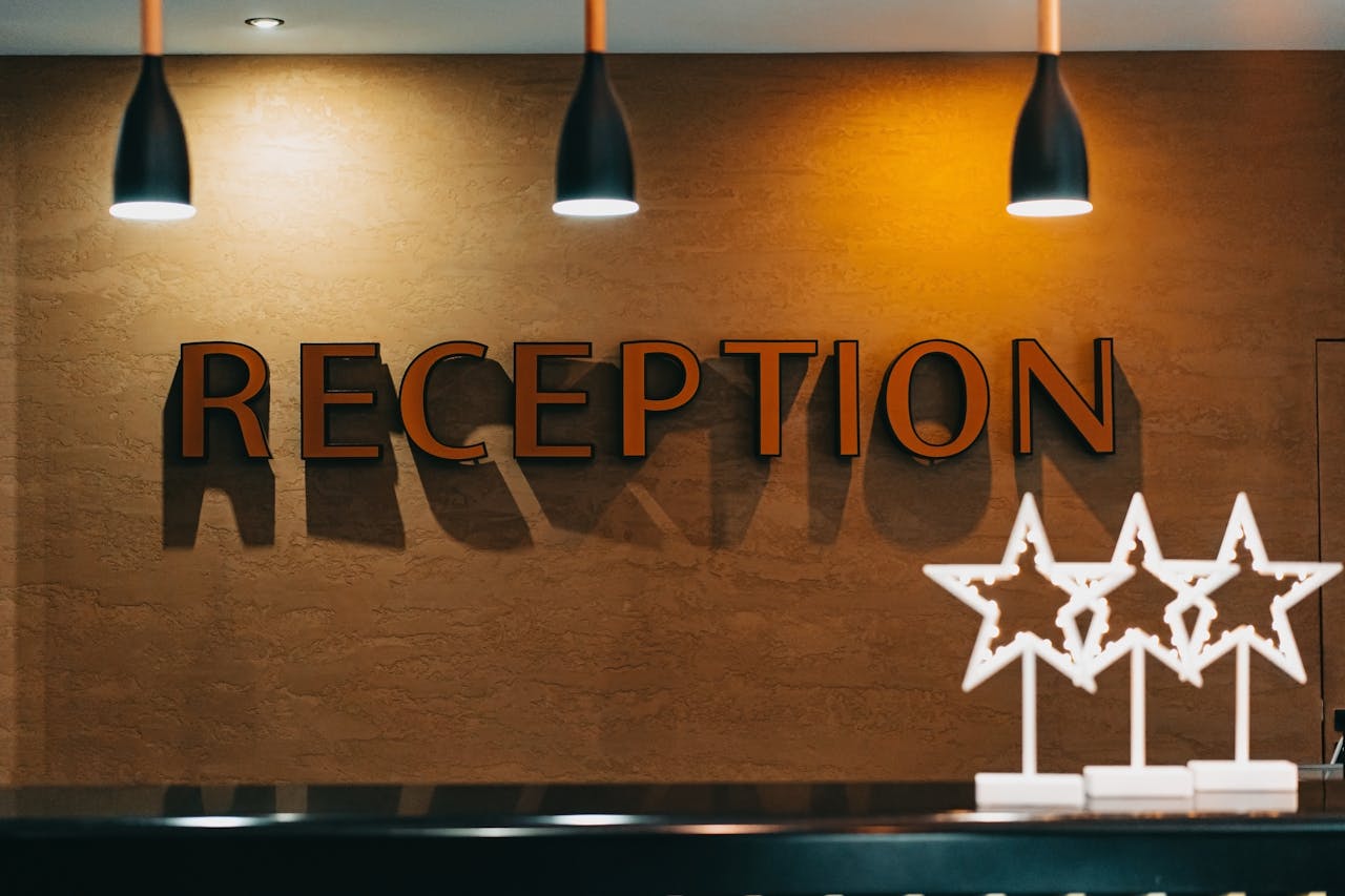 creative-02 Elegant hotel reception area with illuminated signage and decor.