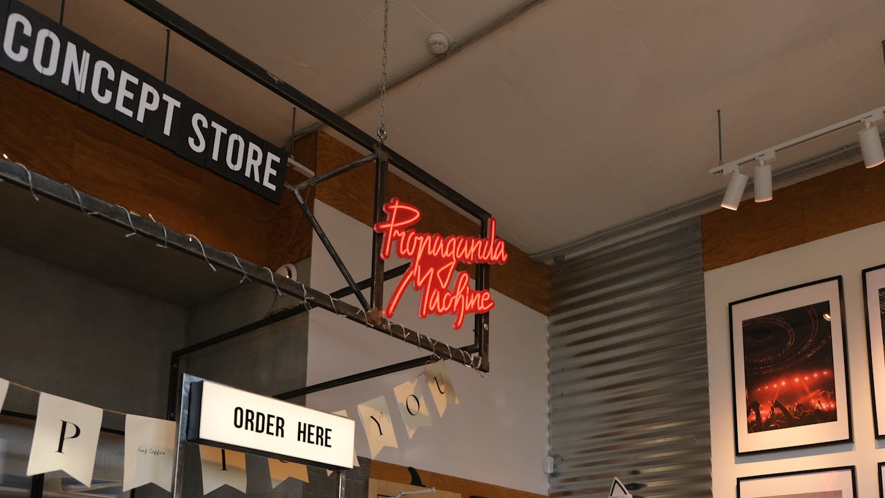 our-story Interior of a modern concept store featuring neon signage and contemporary decor.